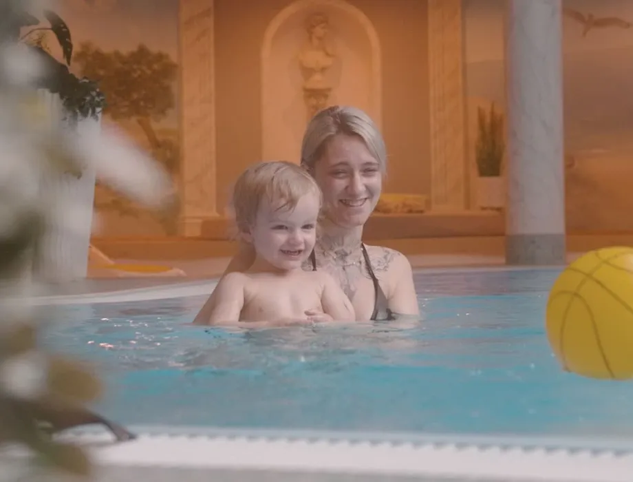Eine Mutter und ihr Kind im Innenpool des Arkona Strandhotels beim Familienurlaub auf Rügen.