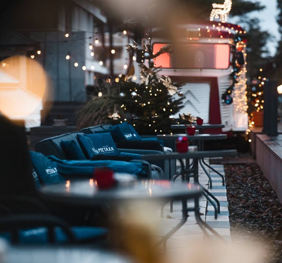 Gemütliche Hotelterrasse mit weihnachtlicher Dekoration, Lichterketten, Sitzgelegenheiten und festlicher Atmosphäre in der Adventszeit.