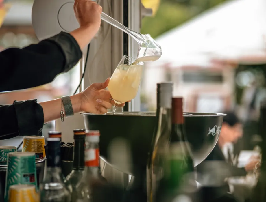 Bartender pours a refreshing drink into a glass on the Arkona Terrace at the Arkona Strandhotel on Rügen