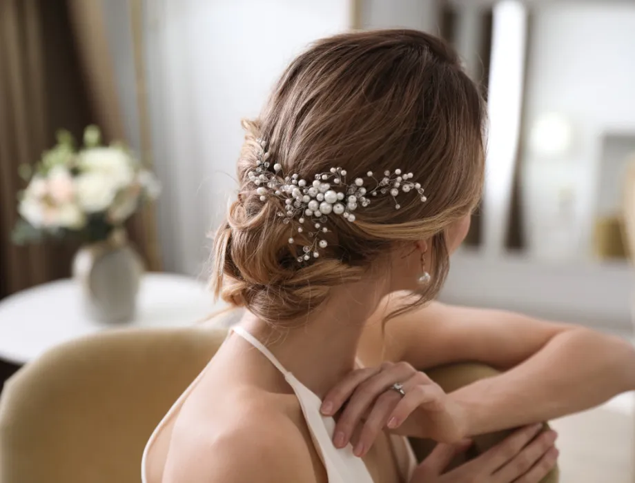 A bride had a bridal styling in Binz and has beautiful white wedding jewelry in her updo.