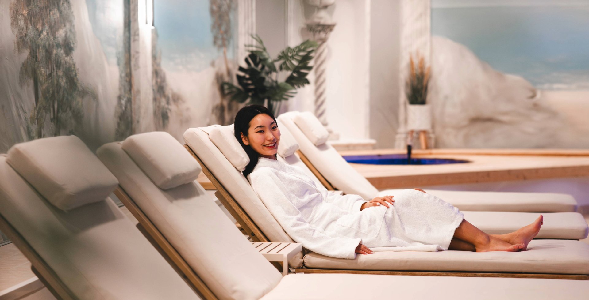Woman lying on a comfortable lounger in the wellness area at Arkona Strandhotel Binz on Rügen