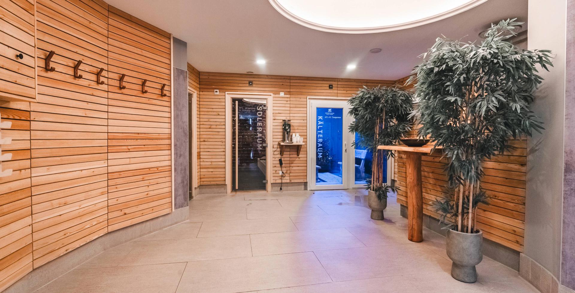 Sauna area at Arkona Strandhotel Binz on Rügen with wooden paneling and access to sauna and cold room